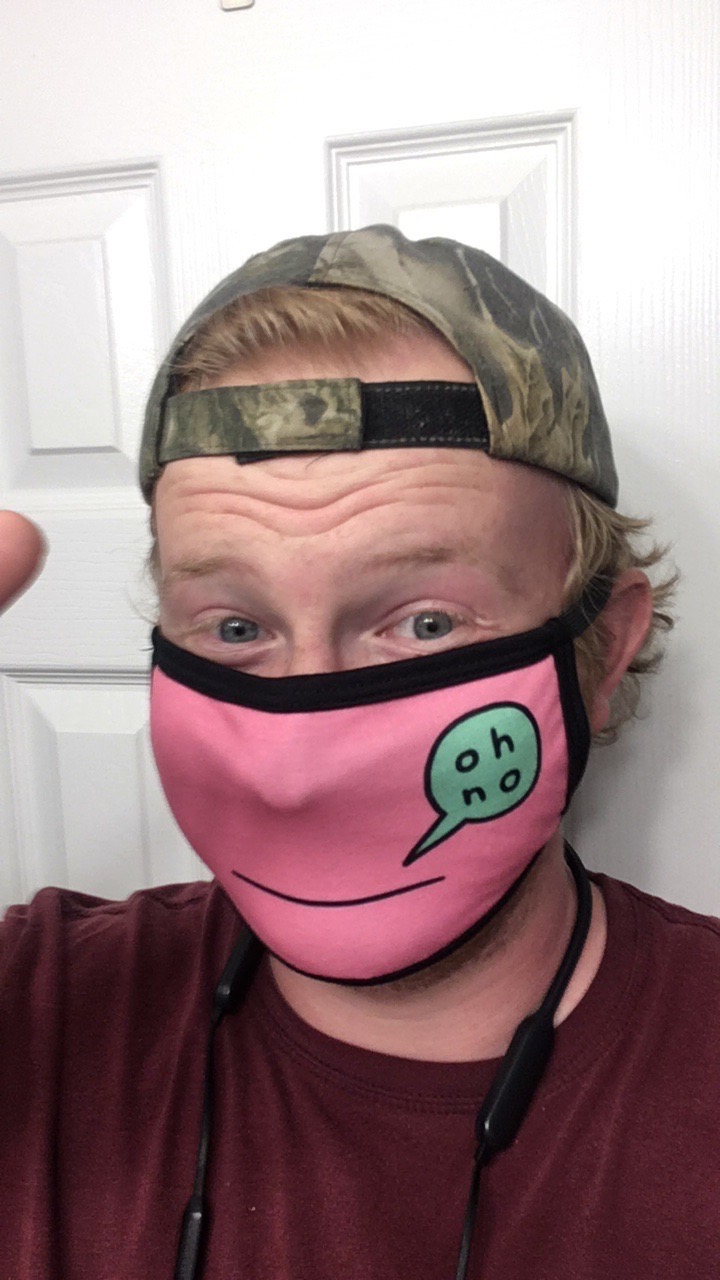 I'm in a pink cloth mask with a green speech bubble that says "oh no"